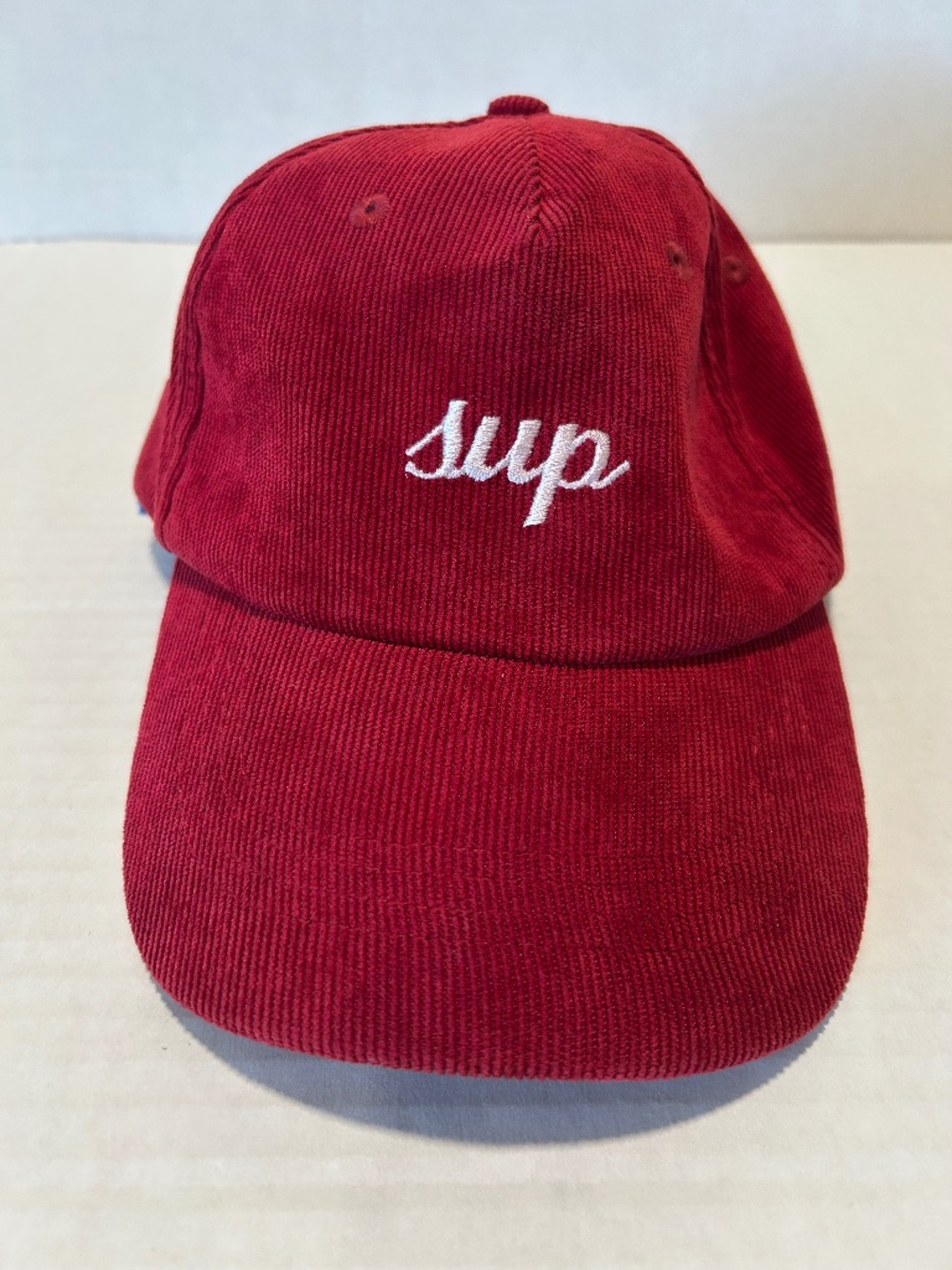Deep Red Curdory hat, "SUP" on front, "BYE" on back